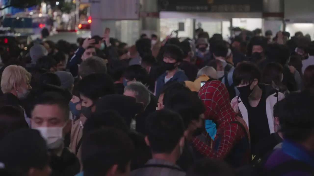 Busy Crowd Moving Around With Masks And Costumes At Shibuya Crossing On Halloween Night In Tokyo Japan Medium Shot