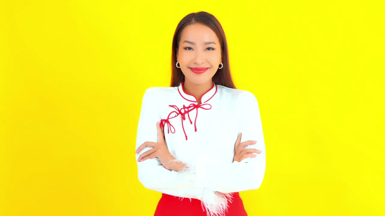 Attractive Asian Girl with Crossed Arms Smiling to Camera Copy Space