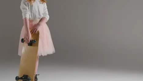 Mid Shot of Little Girl Walking into Frame with Skateboard