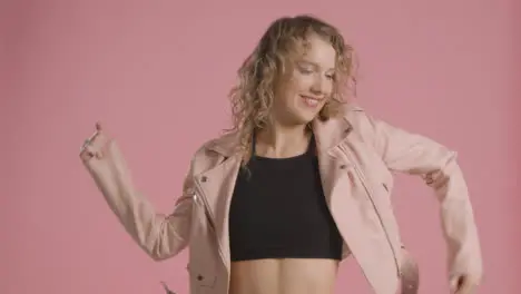 Studio Shot Of Young Woman Having Fun Dancing Against Pink Background 1