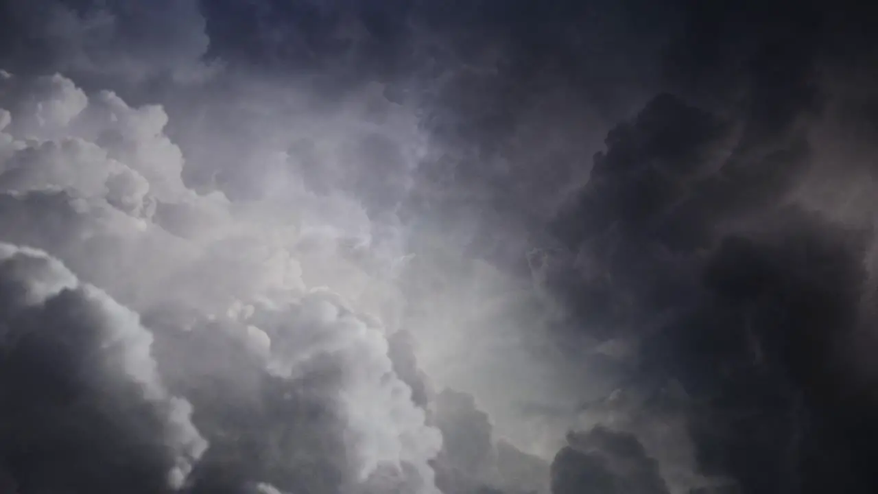 4k view of the lightning flashes among moving clouds in the sky