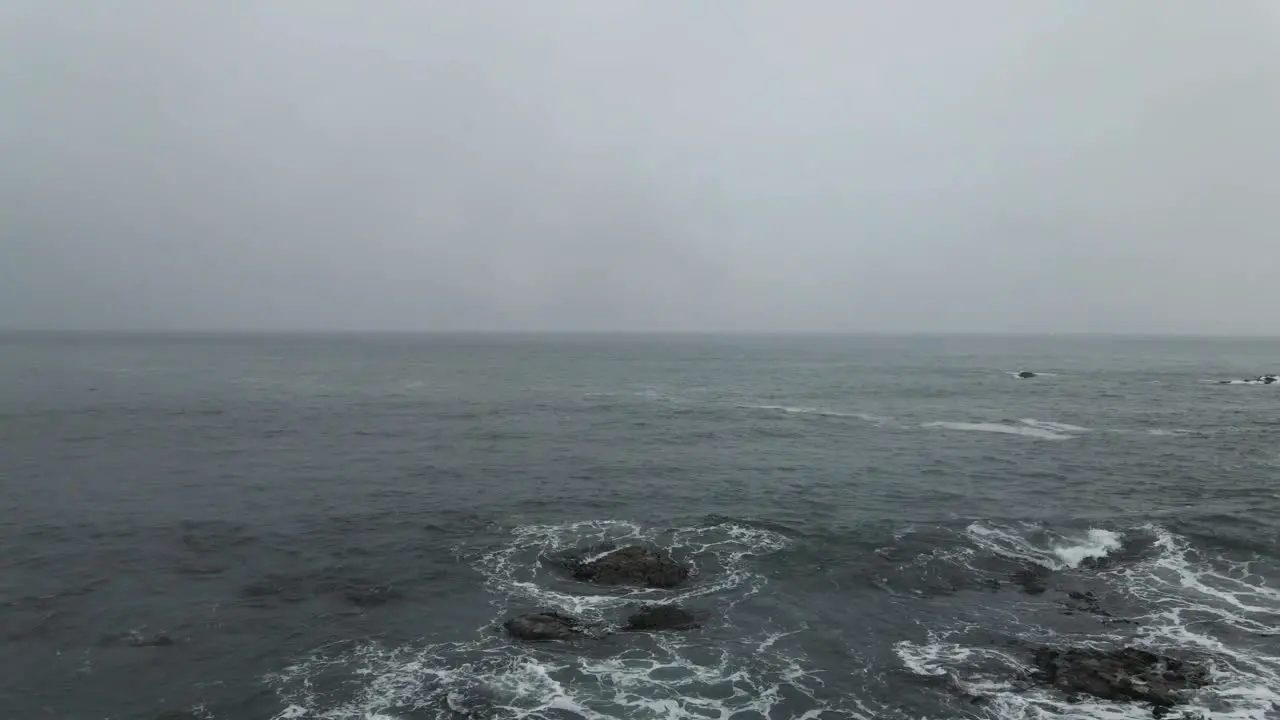 man standing on rocks by the sea