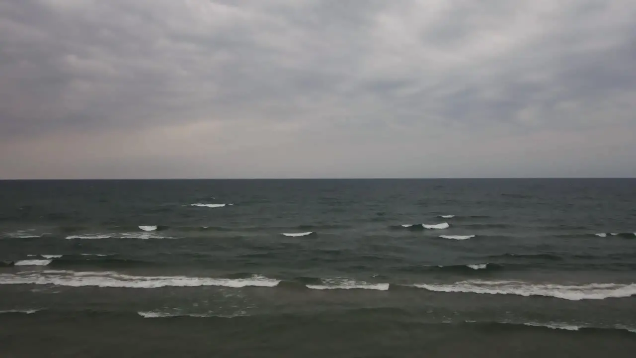 Seagull birds flying over the water during stormy weather