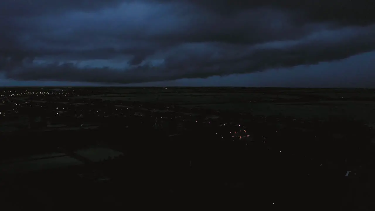 Aerial crane shot view of of evening storm over Mekong Delta in Vietnam from light to dark