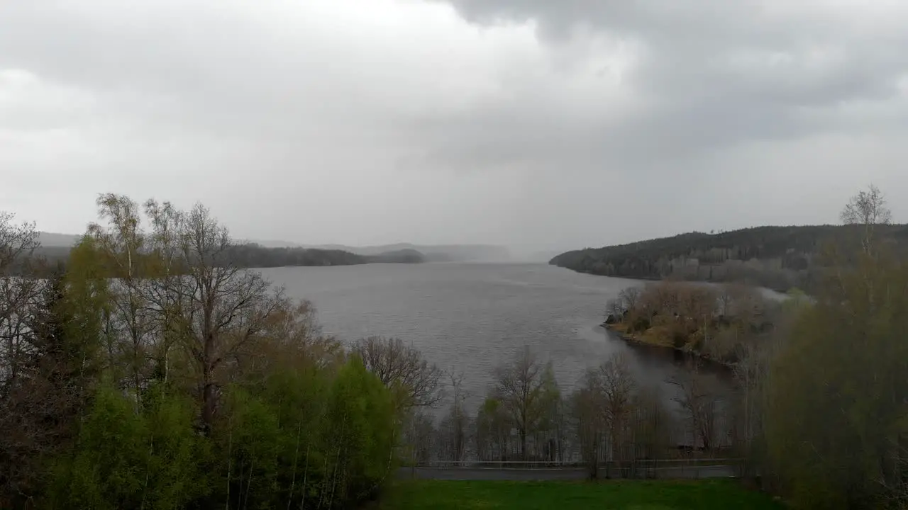 Aerial Shot Of Rain Storm Over A Scenic Lake Dramatic Clouds In The Sky