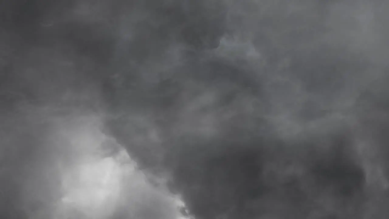 view of lightning striking within gray clouds