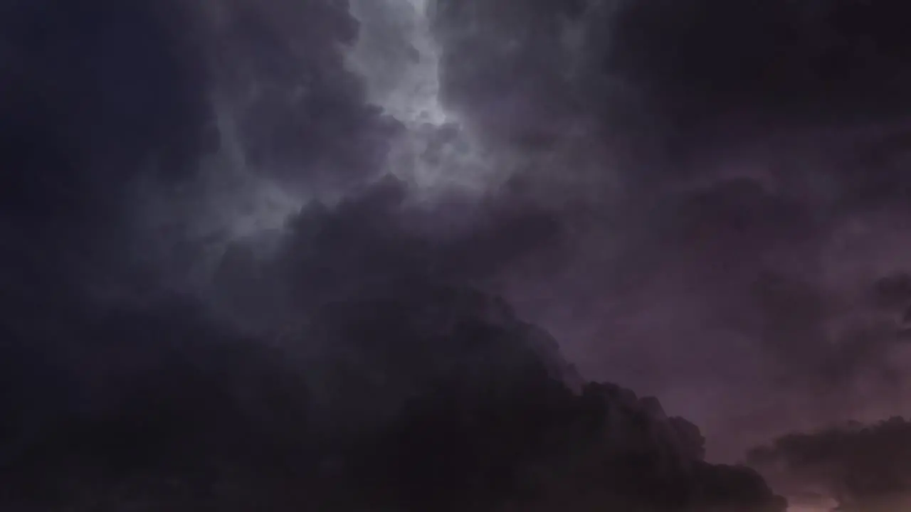 a thunderstorm timelapse with a flash in the dark cloudy sky