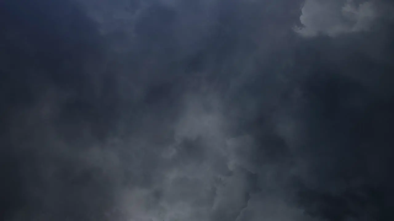 lightning flashes inside dark clouds in the sky thunderstorm 4K