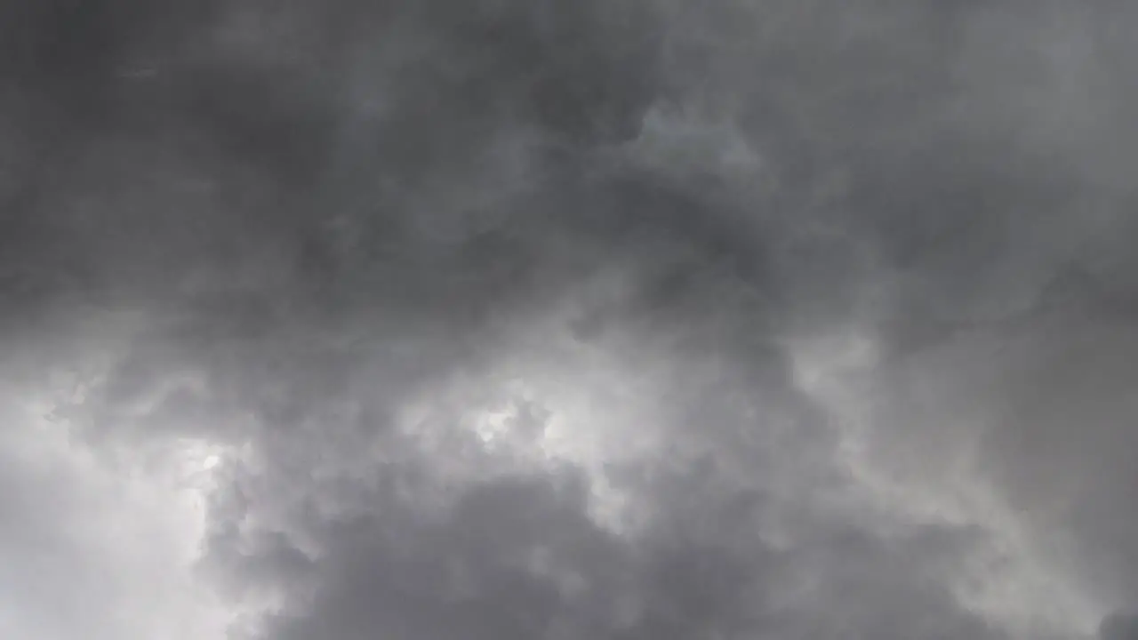 lightning in a storm within a gray cloud pov