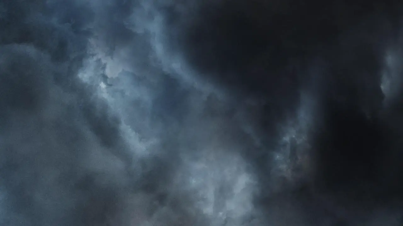 4K thunderstorm inside dark cumulonimbus clouds in dark sky