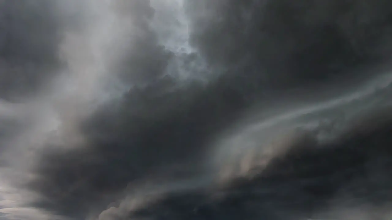 A thunderstorm with lightning striking within the approaching dark clouds