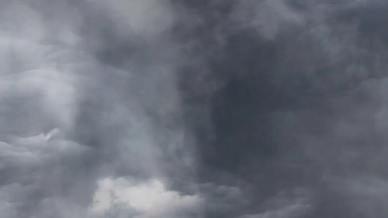 moving cumulonimbus clouds with flashes of lightning in them