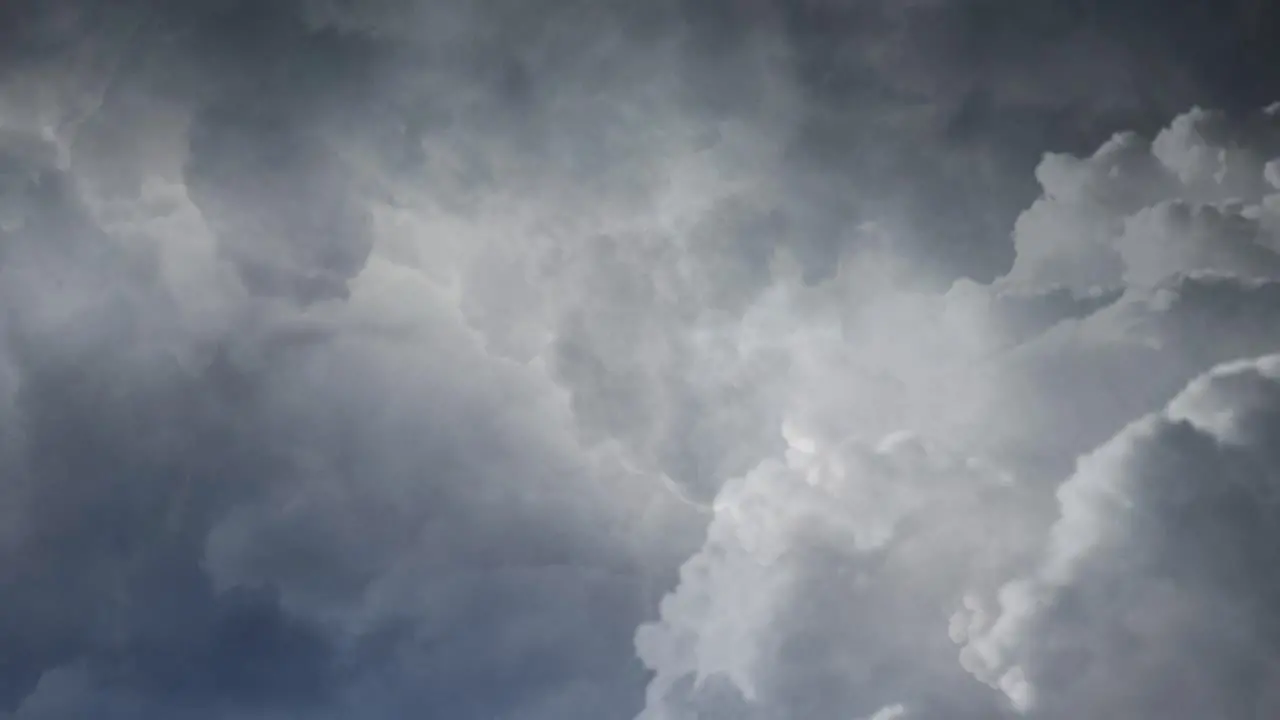 4k view of thunderstorm flying through dark cumulonimbus clouds