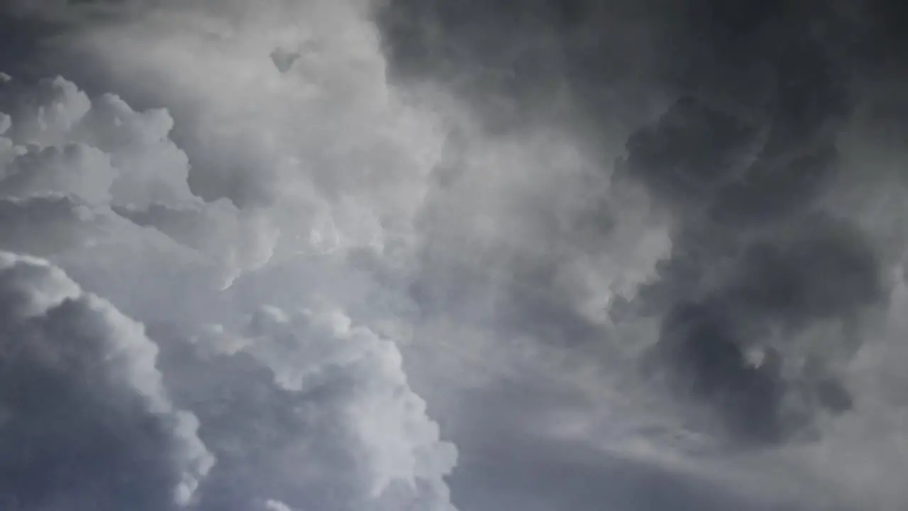 View of lightning flashes and dark clouds moving in the dark sky