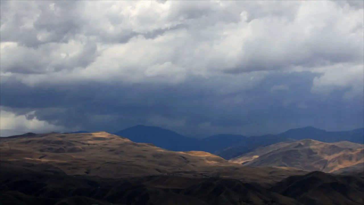 Timelapse of rainclouds over mountains 1