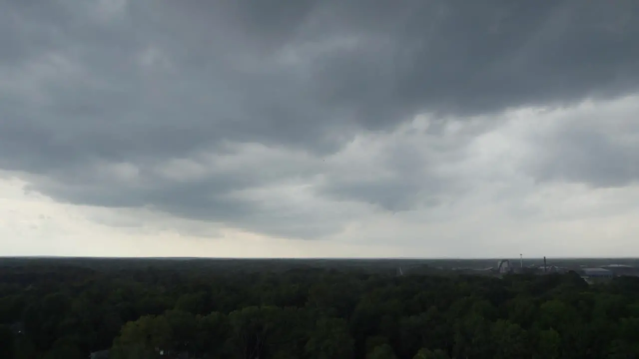 A drone shot of stormy sky with dramatic clouds from an approaching thunderstorm at sunset