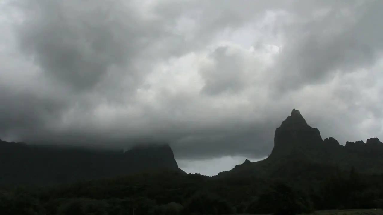 Dark clouds move across mountains