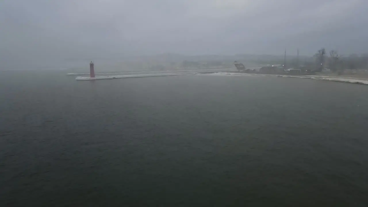 A lighthouse peaking in the distant mist