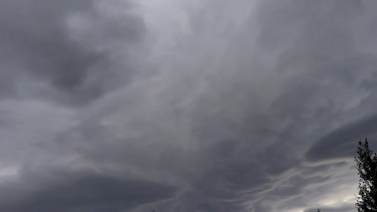 Ominous clouds rolling by overhead with a glimmer of light coming