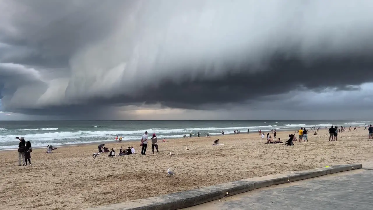 Dramatic thick layer of dark clouds covering the sky at the beach of surfers paradise wet and wild storm season approaching this summer Gold Coast Queensland Australia