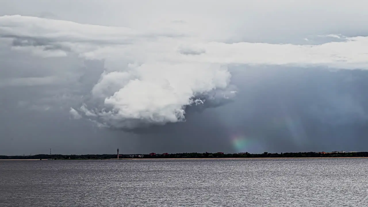 Time lapse footage of dense clouds over Seanad rainbow in background