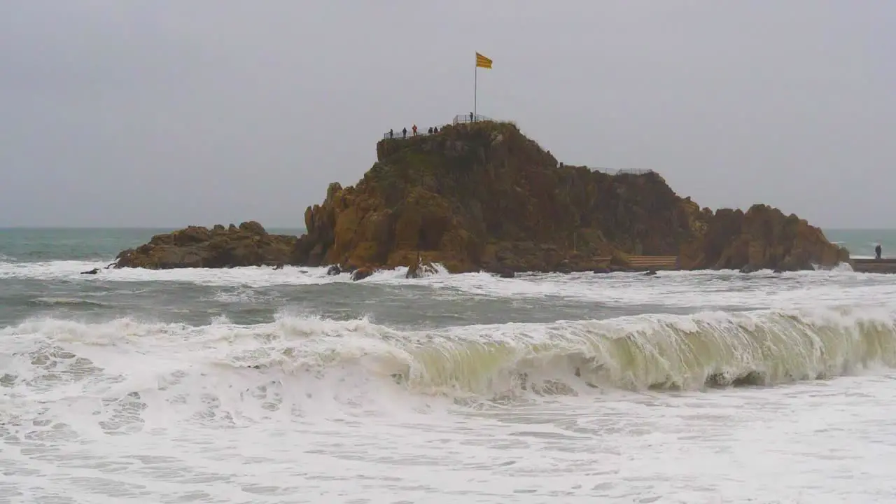 Waves in slow motion on the Costa Brava Mediterranean Sea La Palomera de Blanes in the background