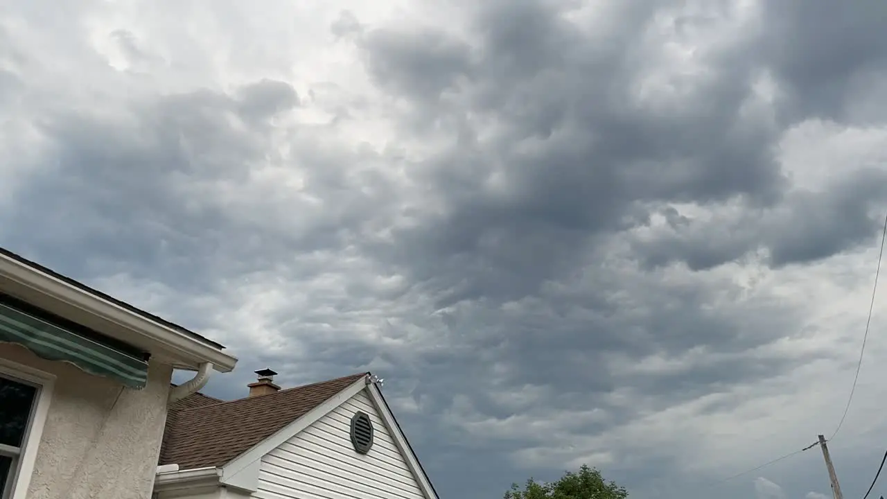 Time lapse of storm clouds over house