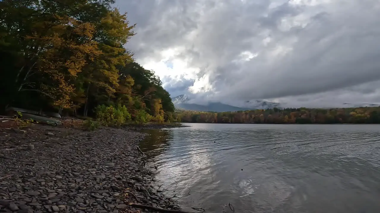 Beautiful rocky lakeshore during peak foliage on a stormy day slow motion