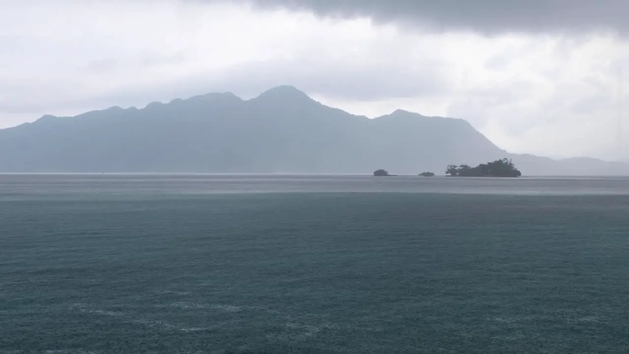 Dramatic grey cloudy and wet raining day overlooking remote tropical island and ocean in Coron Bay Palawan Philippines