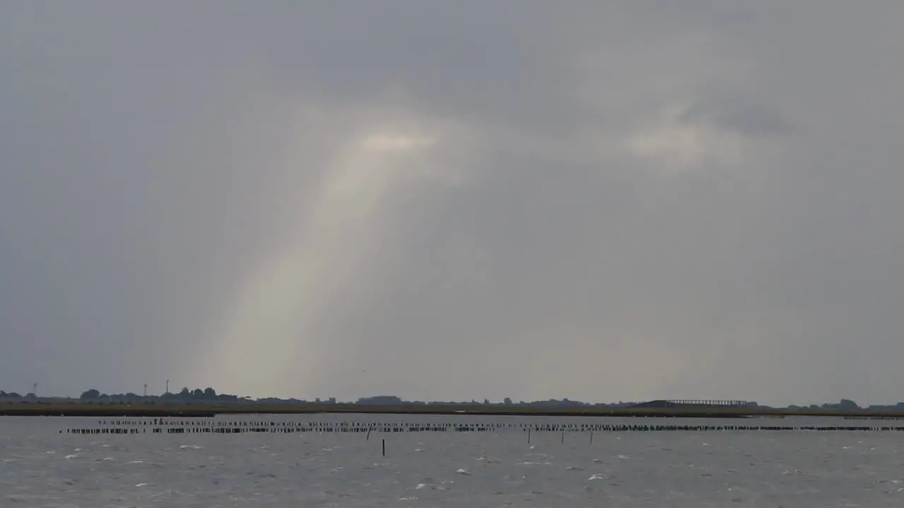 Shaft of sunlight over sea Wadden Sea Netherlands