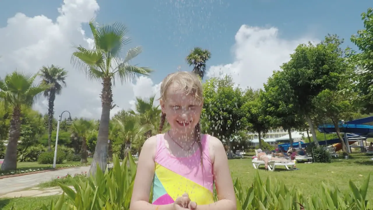 A Young Mother With Her Little Daughter Is Having A Fun Shower By The Pool In The Seaside Resort