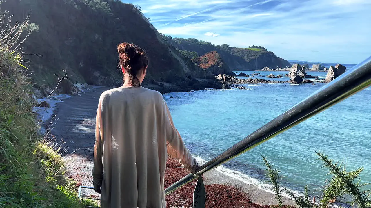 Unrecognizable young girl staring to the ocean in super slow motion shot