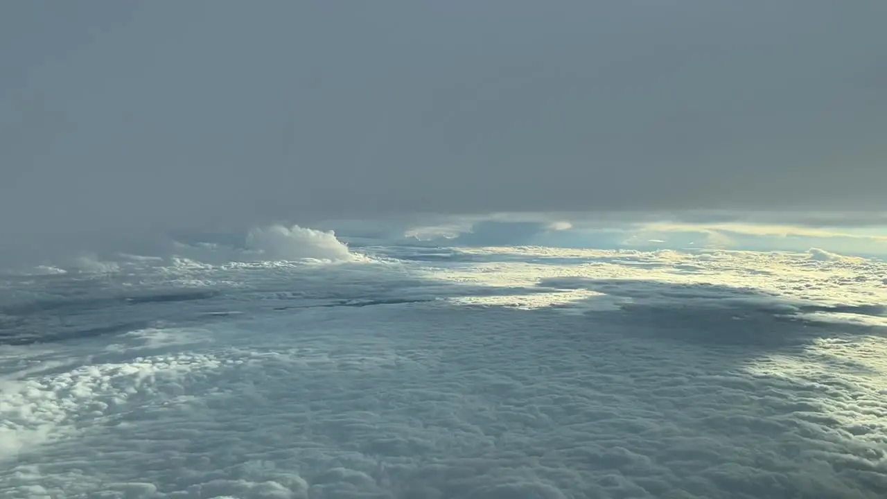 Aerial view from a cockpit while flying between layers of clouds in a stormy day