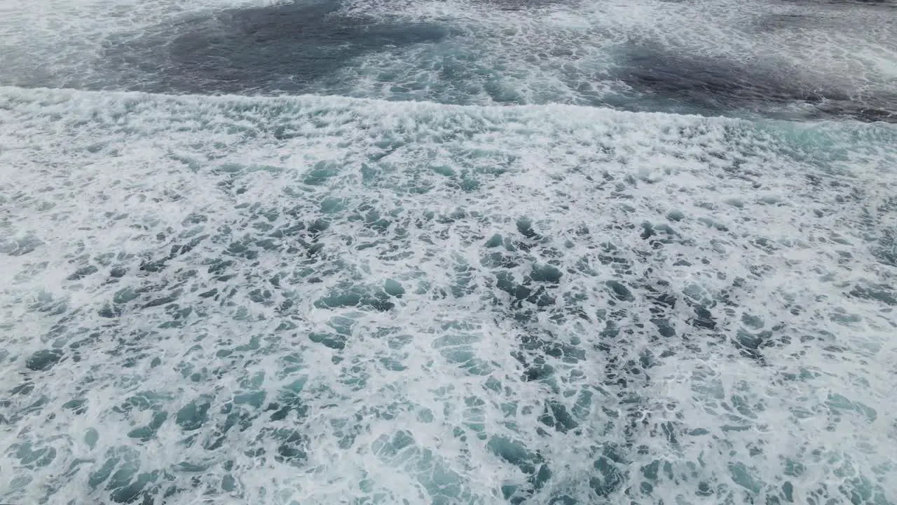 Aerial flight over ocean waves crashing and ocean wash