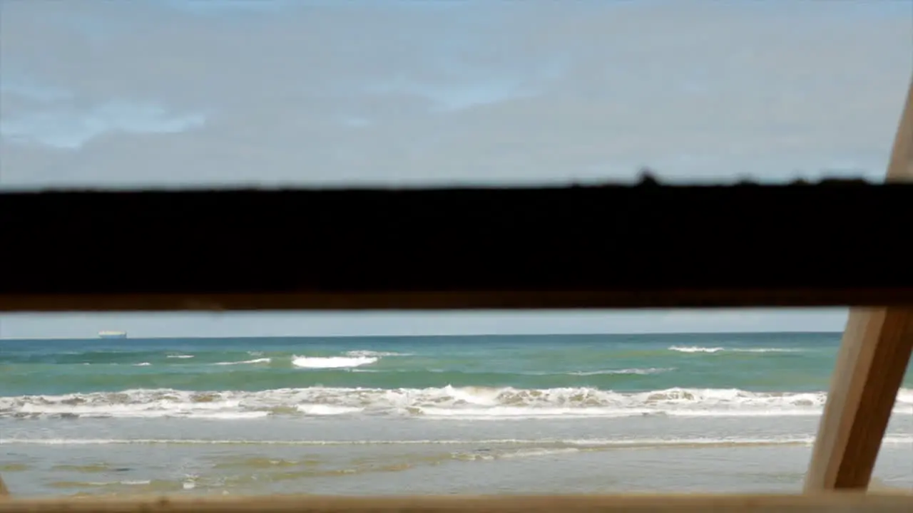 Silhouette of a wooden staircase at an Australian beach with blue sky's and ocean water