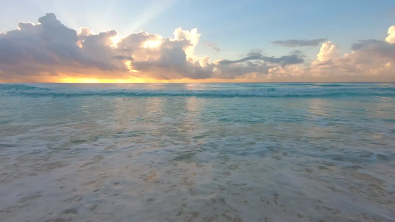 Beach sunrise and crashing waves on the beach