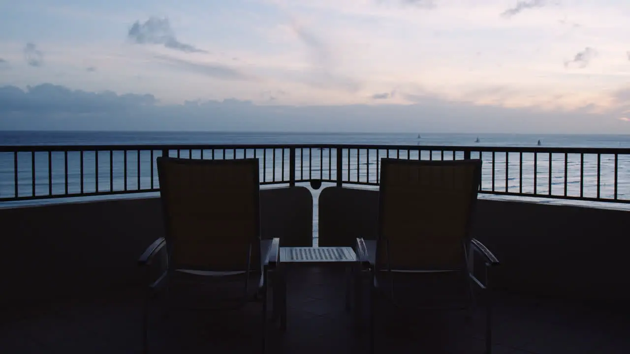 Empty Sunbeds Facing Waikiki Bay and Horizon Line at Sunrise View from Balcony Hawaii