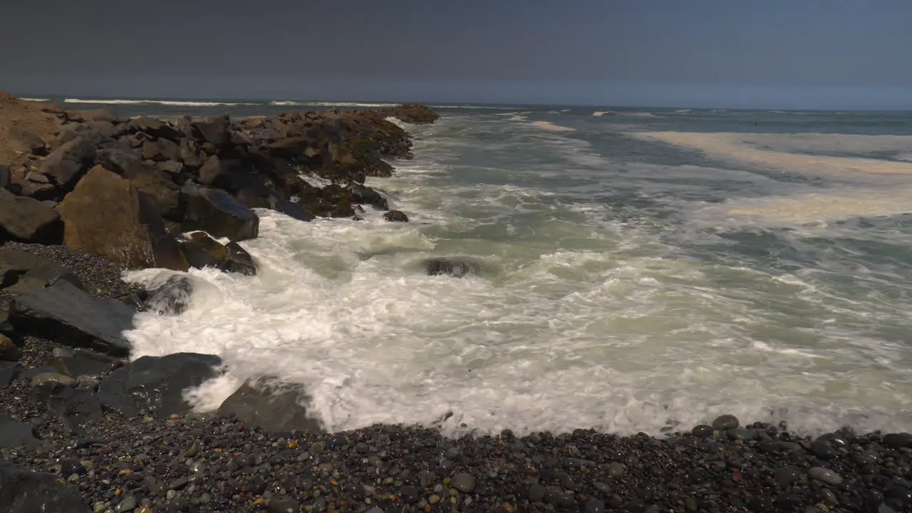 Ocean Hitting Small Rocks in Peru Beach