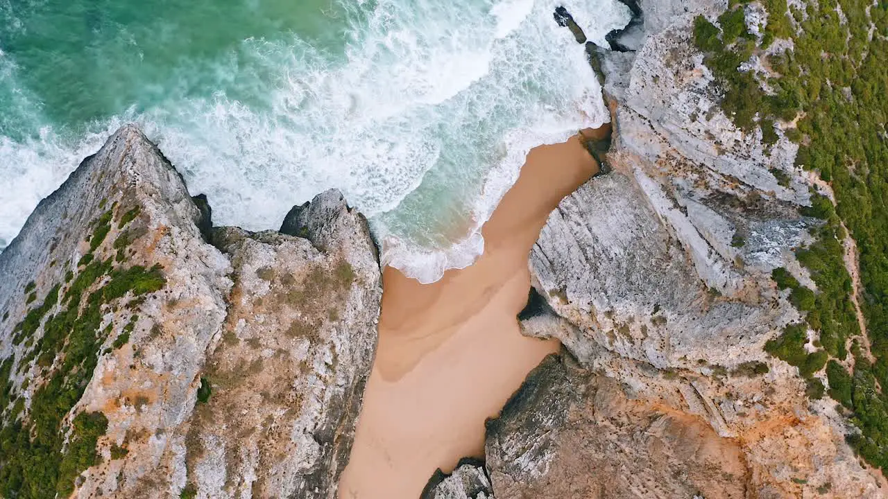 Beach areal view bird's eye view of breaking waves on tropical beach