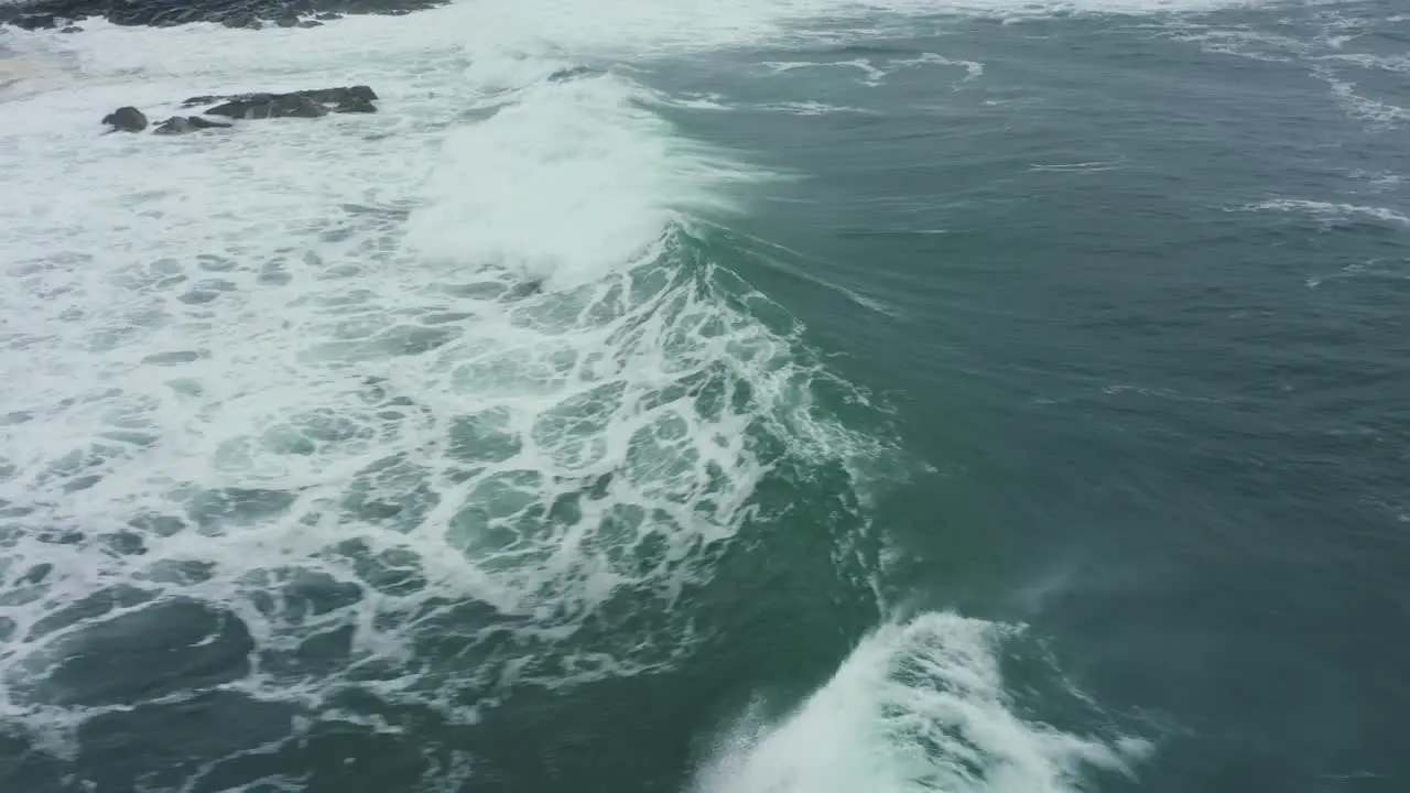 Aerial View 4K following breaking wave