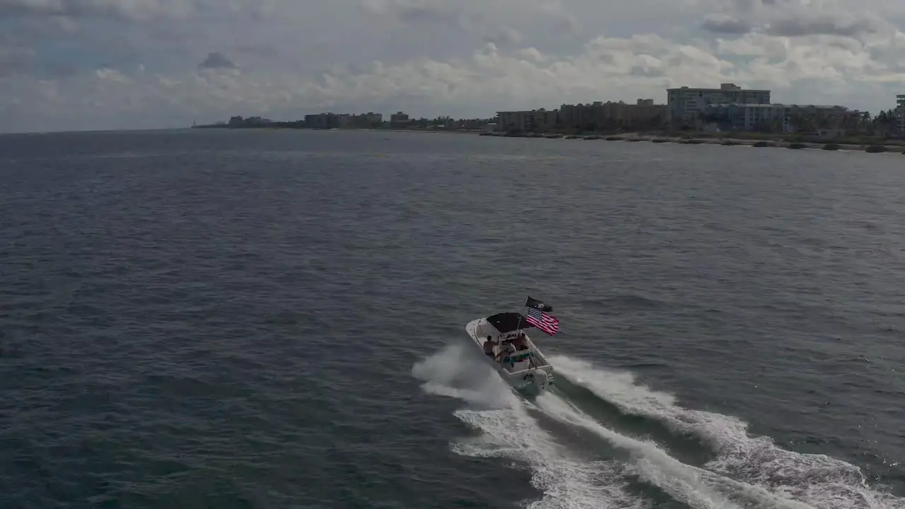 aerial of a small boat with an american flag on the back