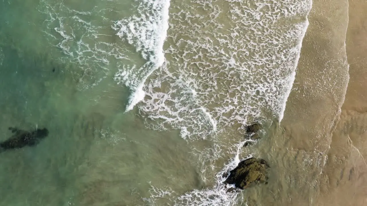 Ocean Waves Splashing On Sandy Shore At Lusty Glaze Beach In Newquay United Kingdom