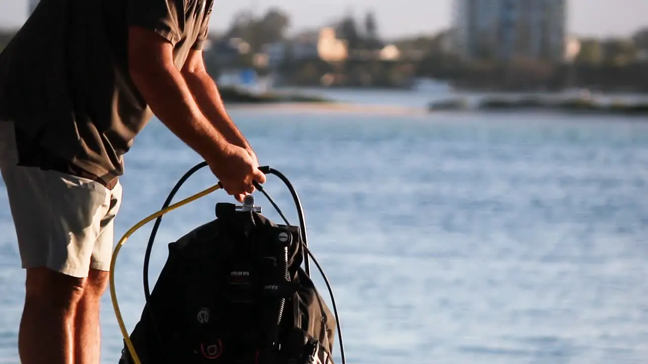 Person setting up scuba diving equipment