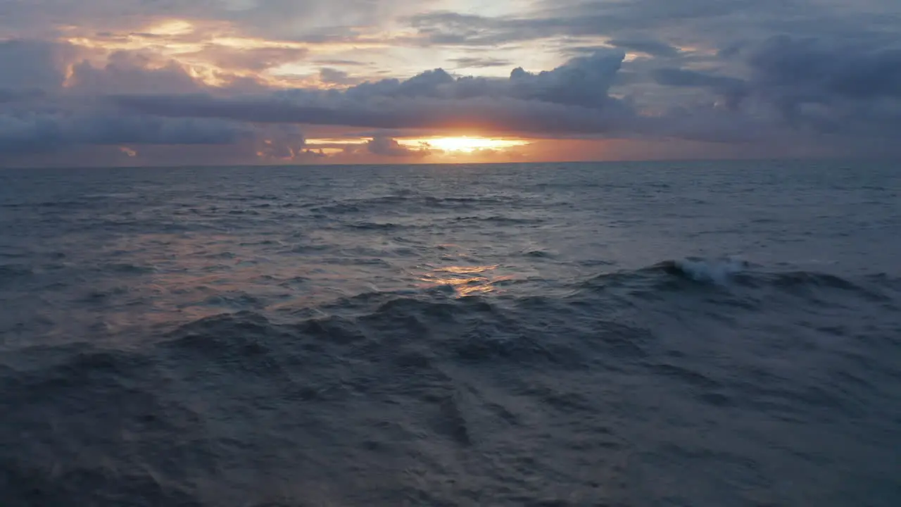 Small waves on ocean surface during warm evening light Blue ocean in orange evening sunset light in Bali