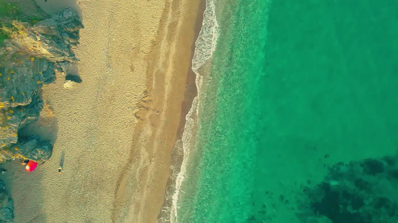 Drone moving upwards at the beach high angle view