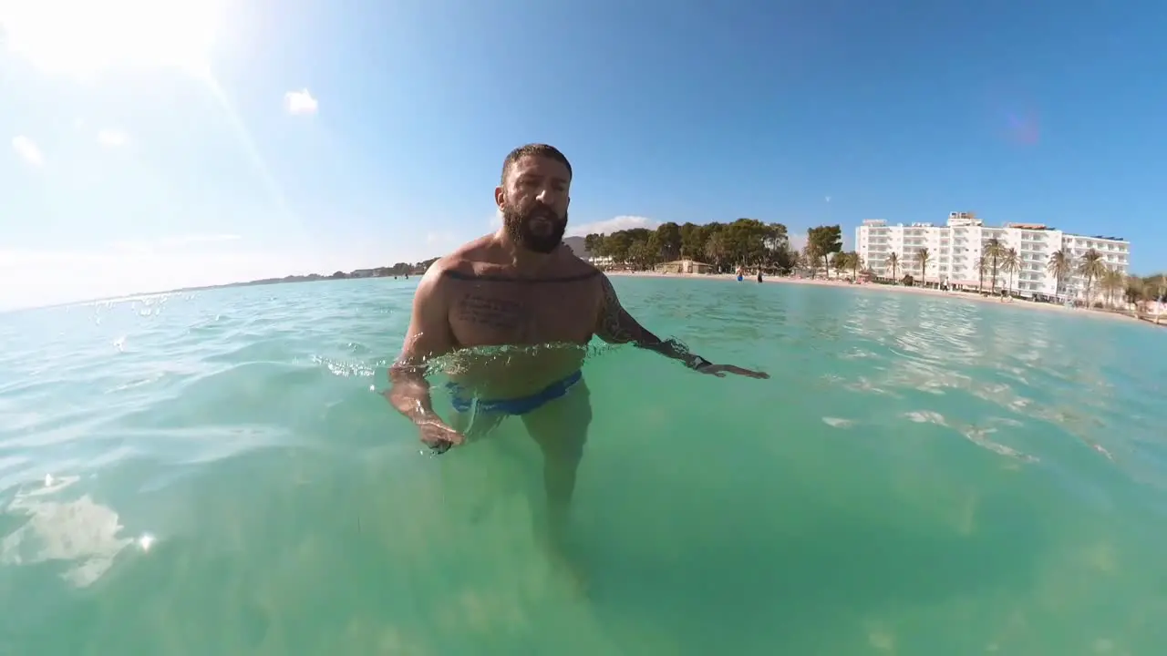 man walking into the sea