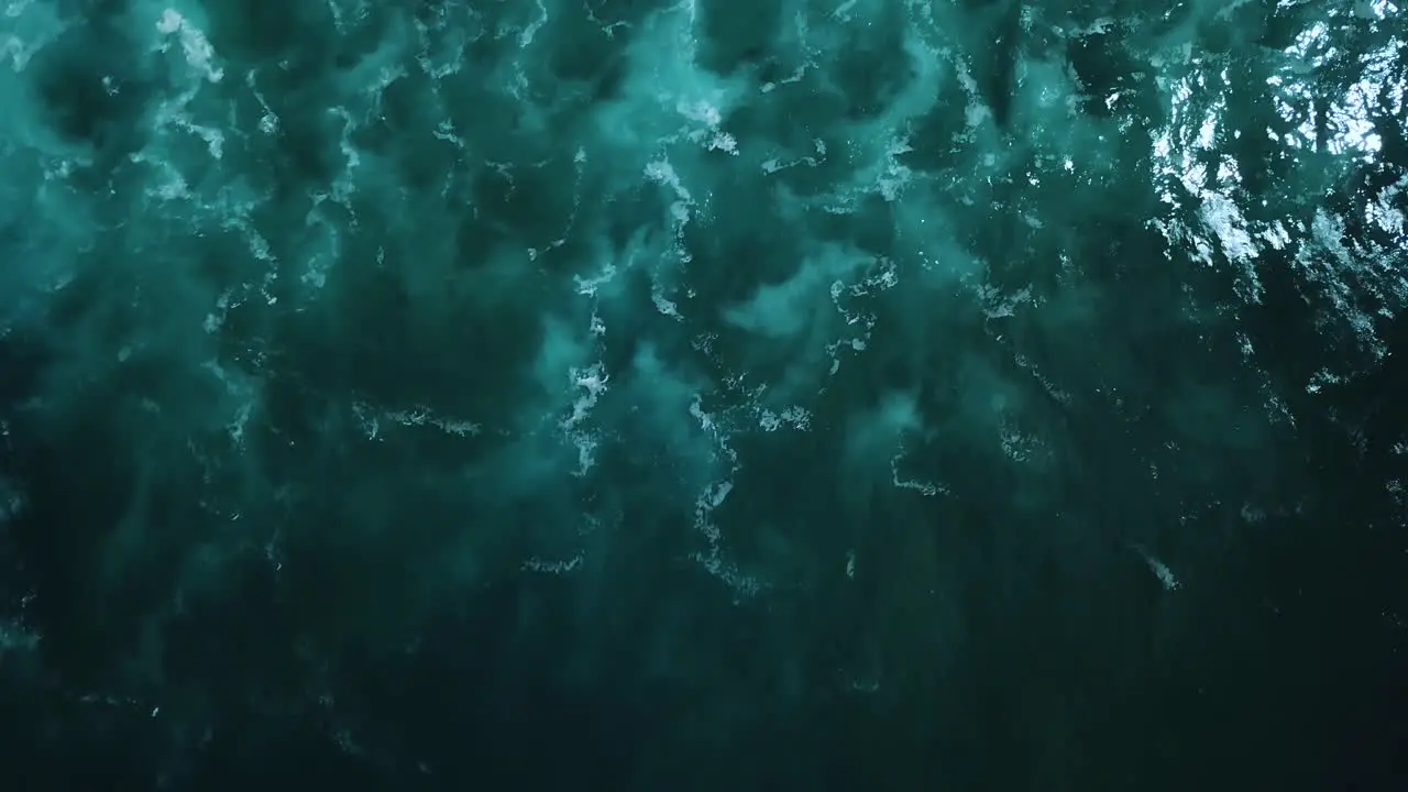 Aerial footage above the dark murky and rough waters found on the North Shore coast of Oahu Hawaii