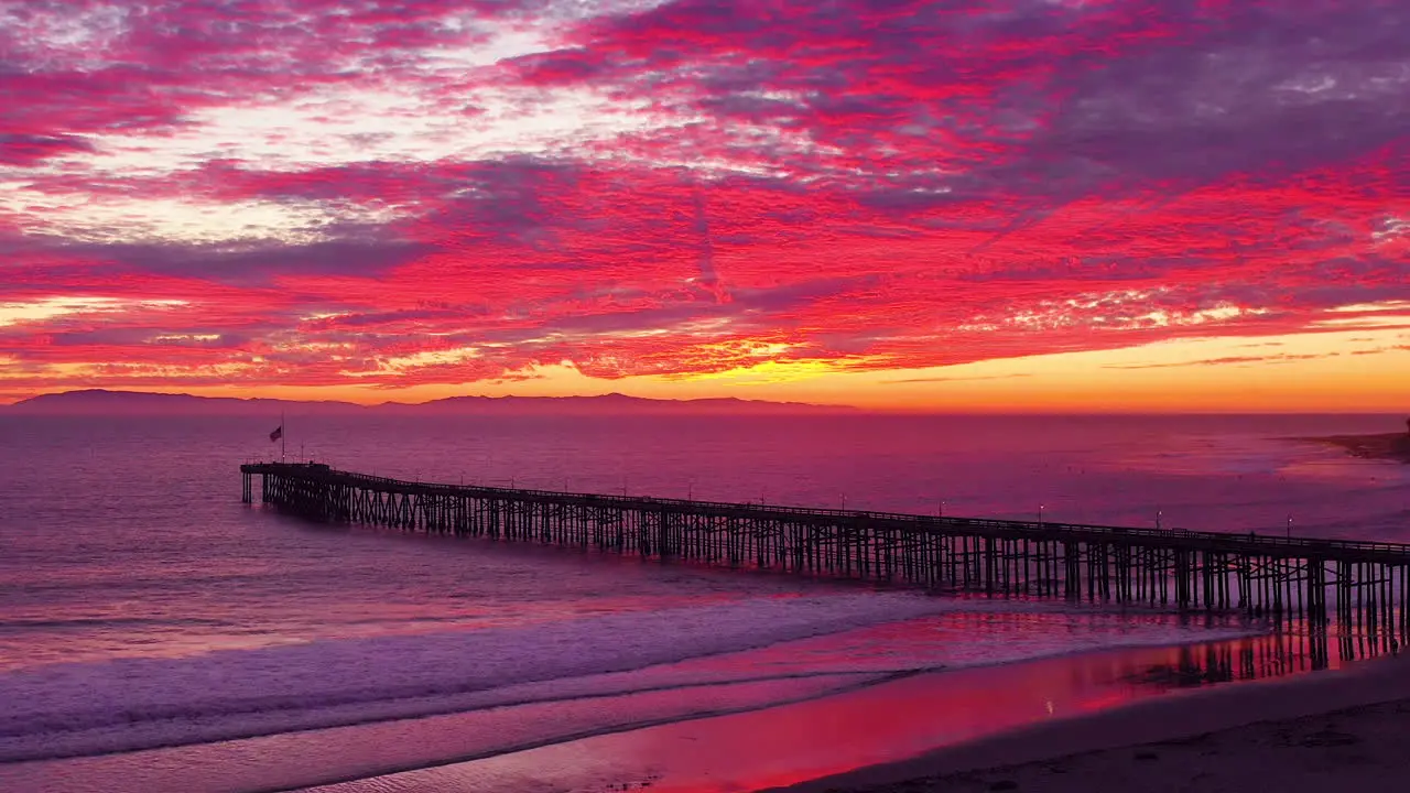 An astonishing sunset aerial shot over a long pier and the Pacific Ocean and Channel Islands in Ventura Southern California 3