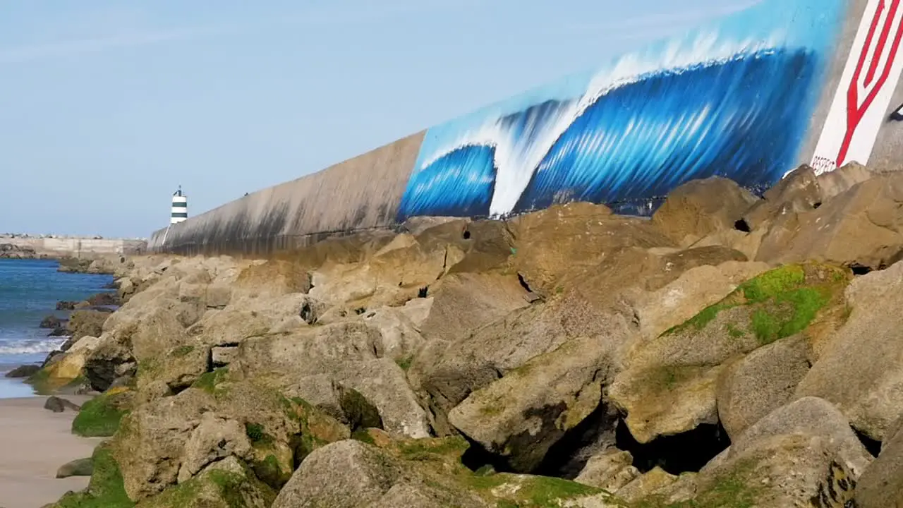 Slow motion still shot of Medão Beach wave mural painting breakwall Supertubos wall Peniche Europe 1920x1080 HD