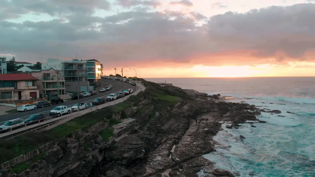 Beachside Town on Headland at Sunrise Drone 4K